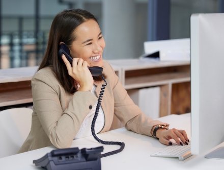 Woman speaking on phone at desk