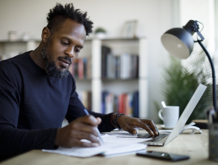 Man writing at desk