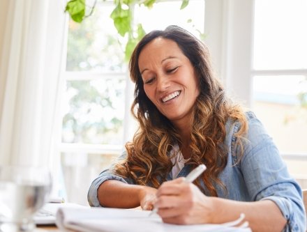 woman smiling at notebook