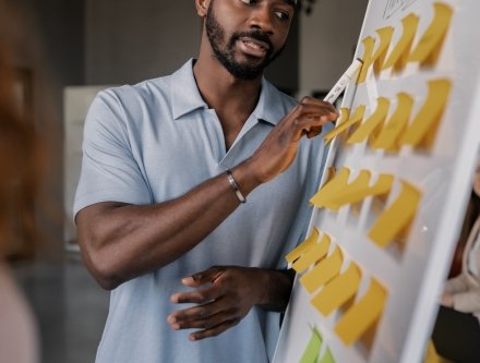 man looking at whiteboard