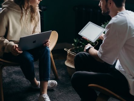 young lady and young man looking at paper