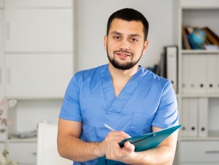 Man in scrubs in an office setting