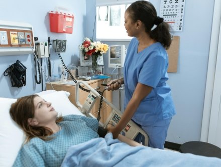 Nurse assisting patient in medical facility